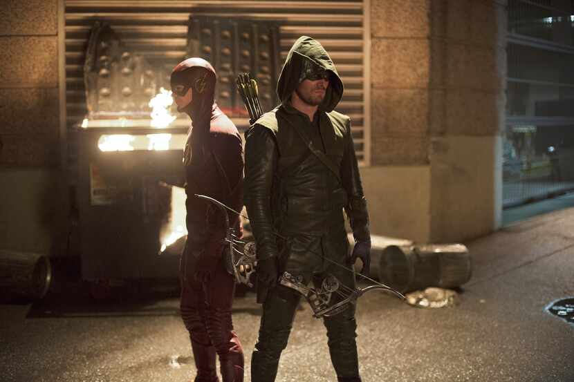 Grant Gustin as The Flash and Stephen Amell as The Arrow