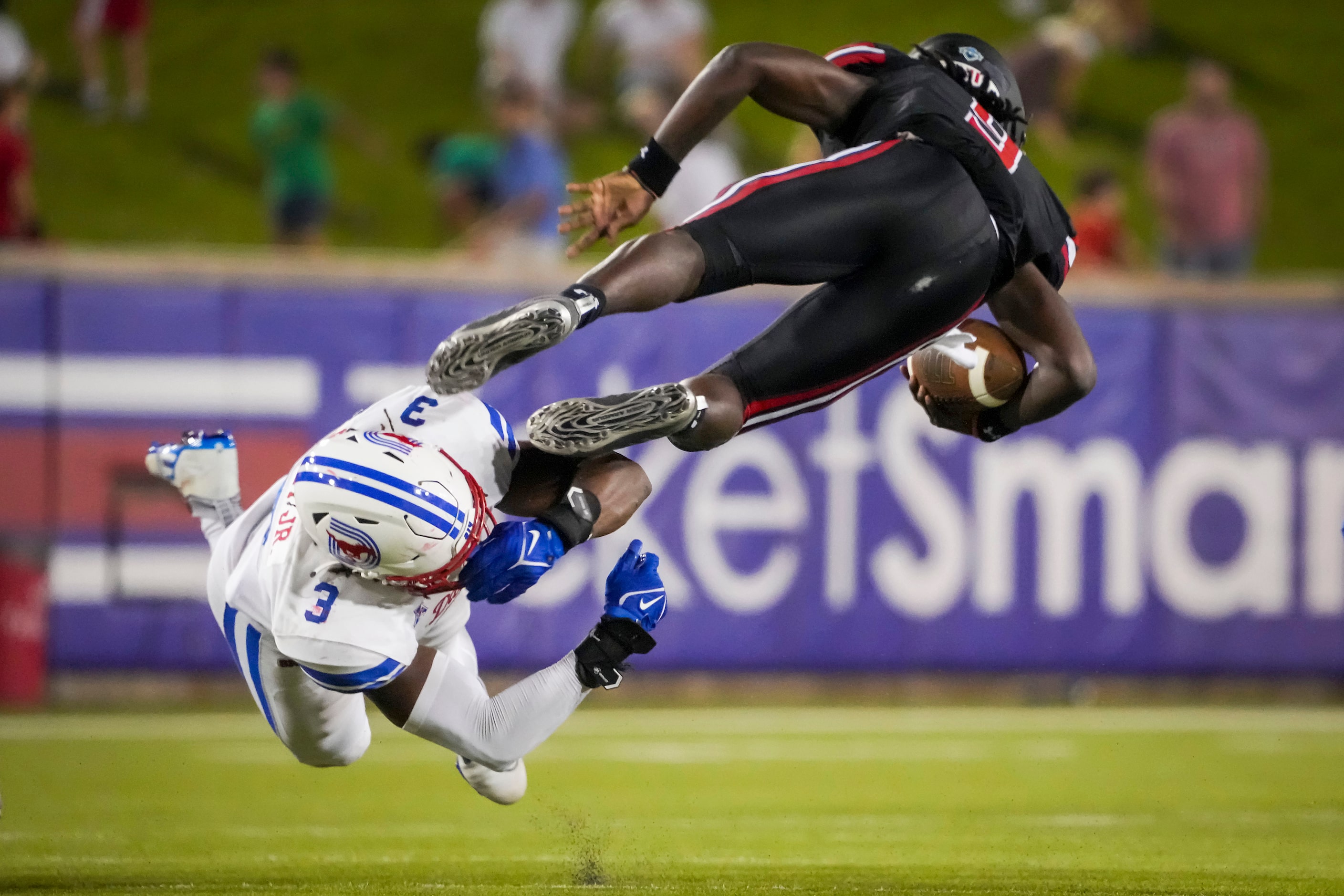 Lamar Cardinals quarterback Mike Chandler (9) is tripped up by SMU defensive end Gary Wiley...