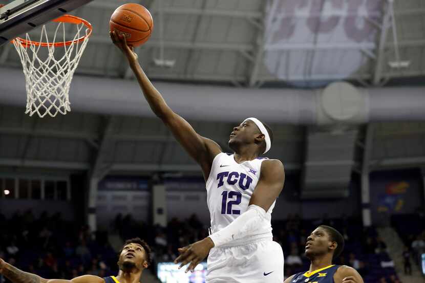 TCU forward Kouat Noi (12) goes up for a shot in front ov West Virginia defenders in the...