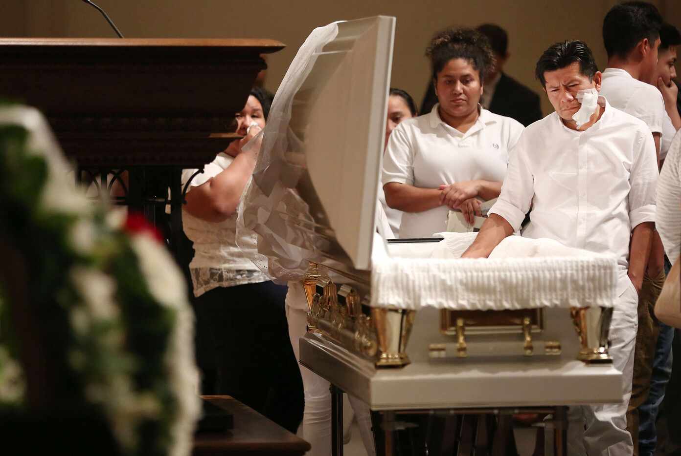 Jose Fiscal takes a moment with his deceased daughter, 12-year-old Linda Rogers, during her...