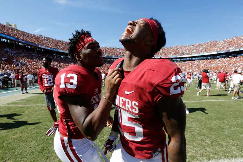 Oklahoma Sooners safety Ahmad Thomas (13) and Oklahoma Sooners running back Joe Mixon (25)...