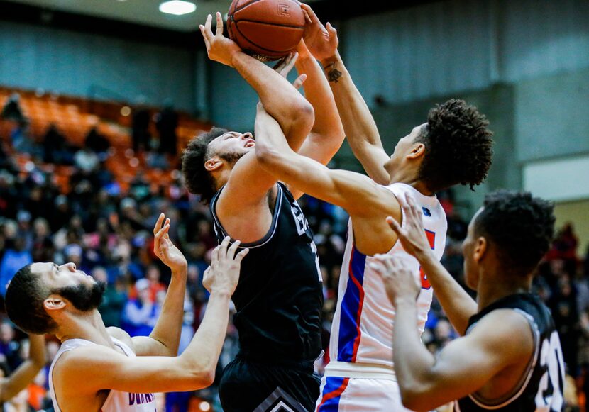 Denton Guyer junior forward JaKobe Coles, center left, and Duncanville junior guard Micah...