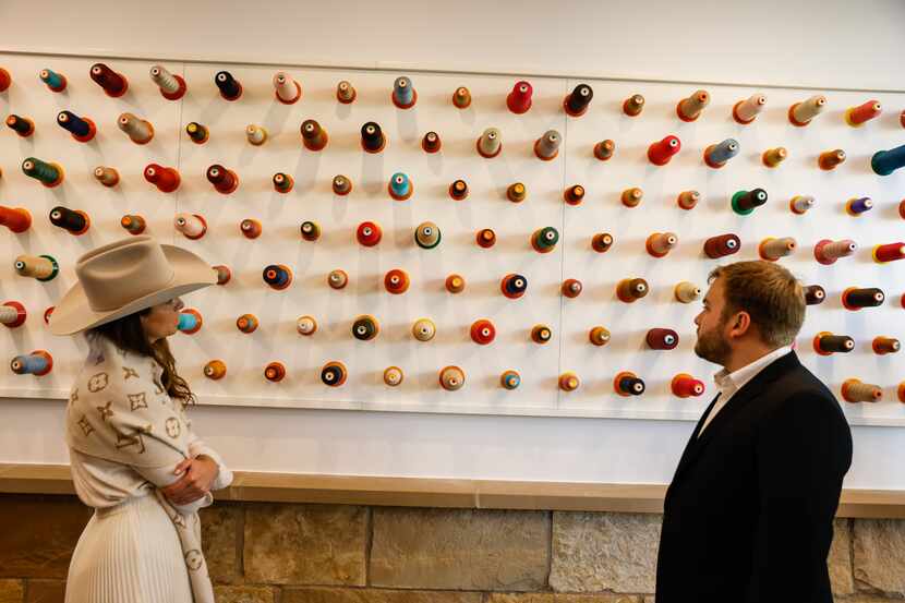 Visitors study decorations on a wall at the Louis Vuitton workshop at the company's 105-acre...