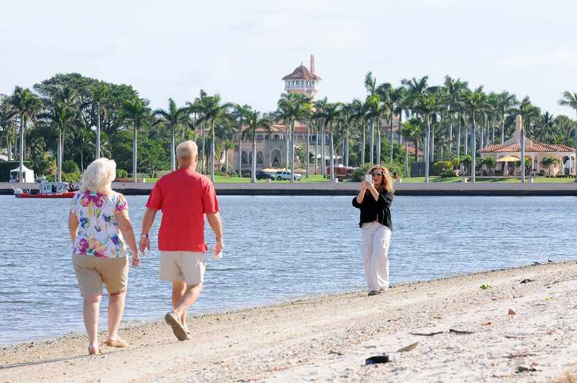 Palm Beach, Fla., residents take selfies in front of the Mar-a-Lago Resort where...