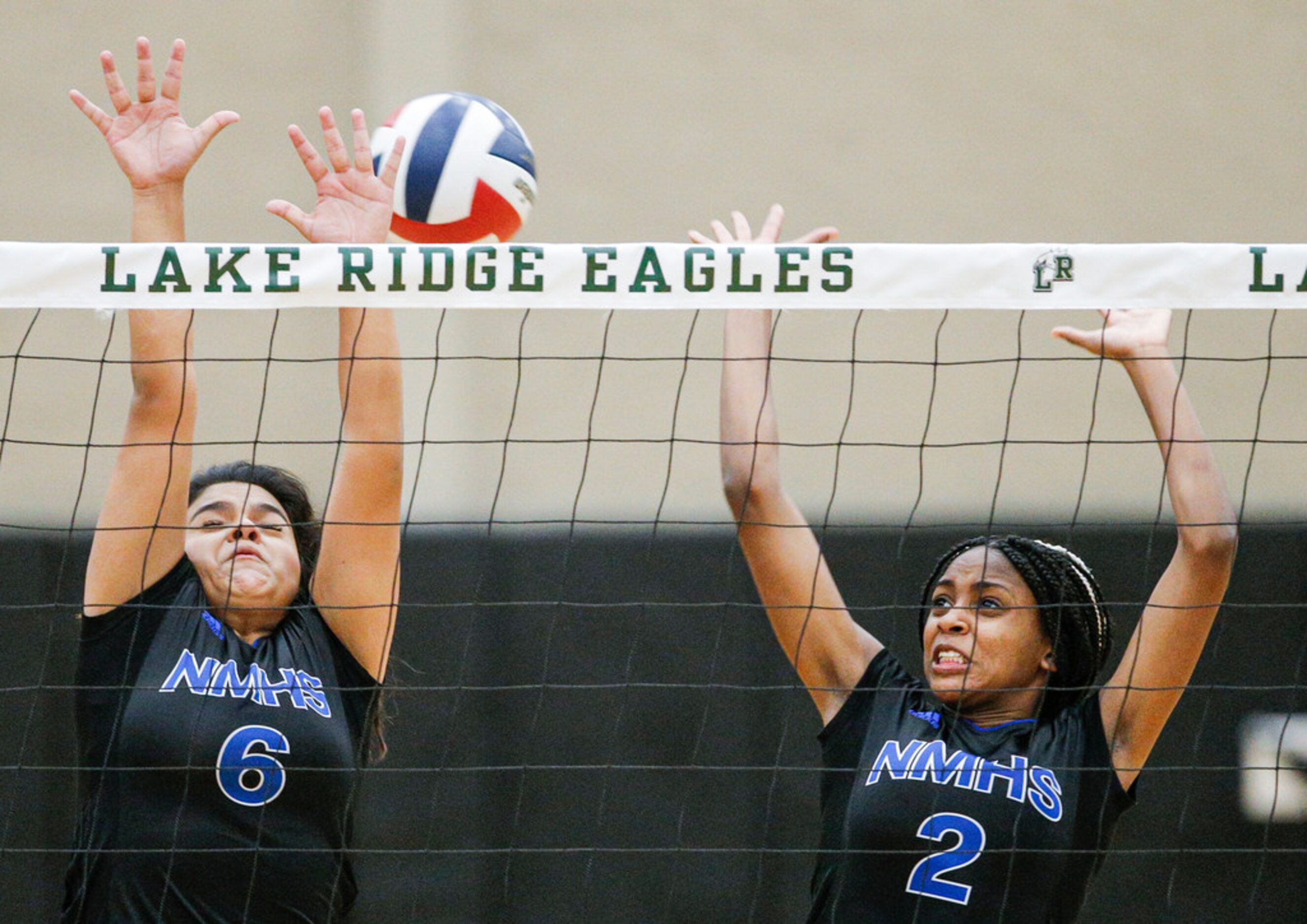 North Mesquite senior Mallory Garcia (6) and freshman KK Daniyan (2) attempt to block a...