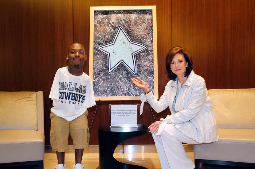 Gene Jones (right) poses for a photo with artist Kendrell Daniels who painted The Star, an...