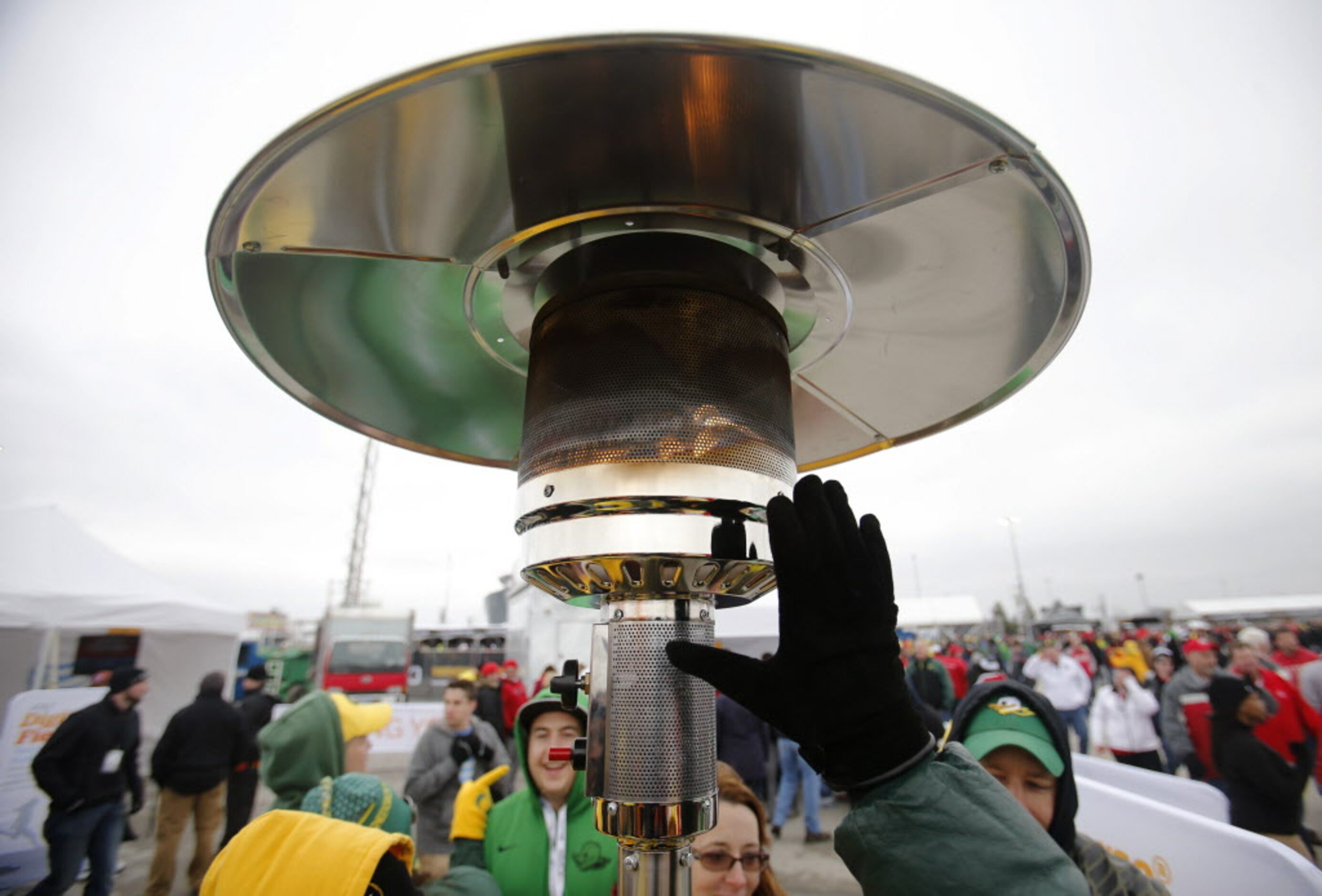 Steve Plowman of Portland warms his hands before a game between Oregon and Ohio State...