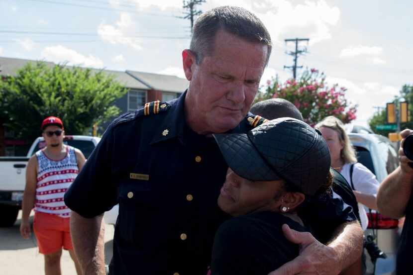 Officer W. C. Humphrey embraced Kristen Duncan, 25, of Arlington, during the Black Lives...