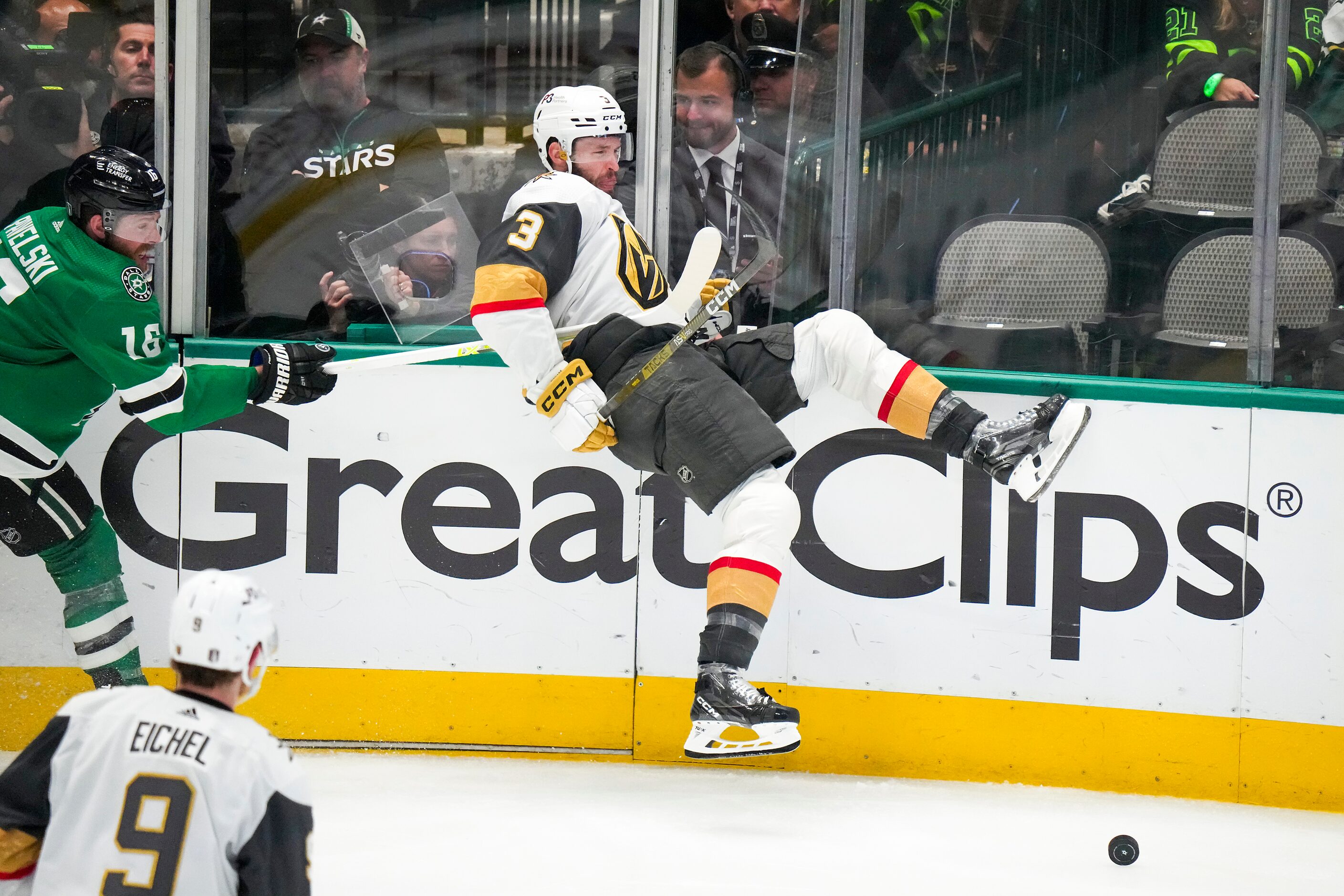 Vegas Golden Knights defenseman Brayden McNabb (3) is checked by Dallas Stars center Joe...