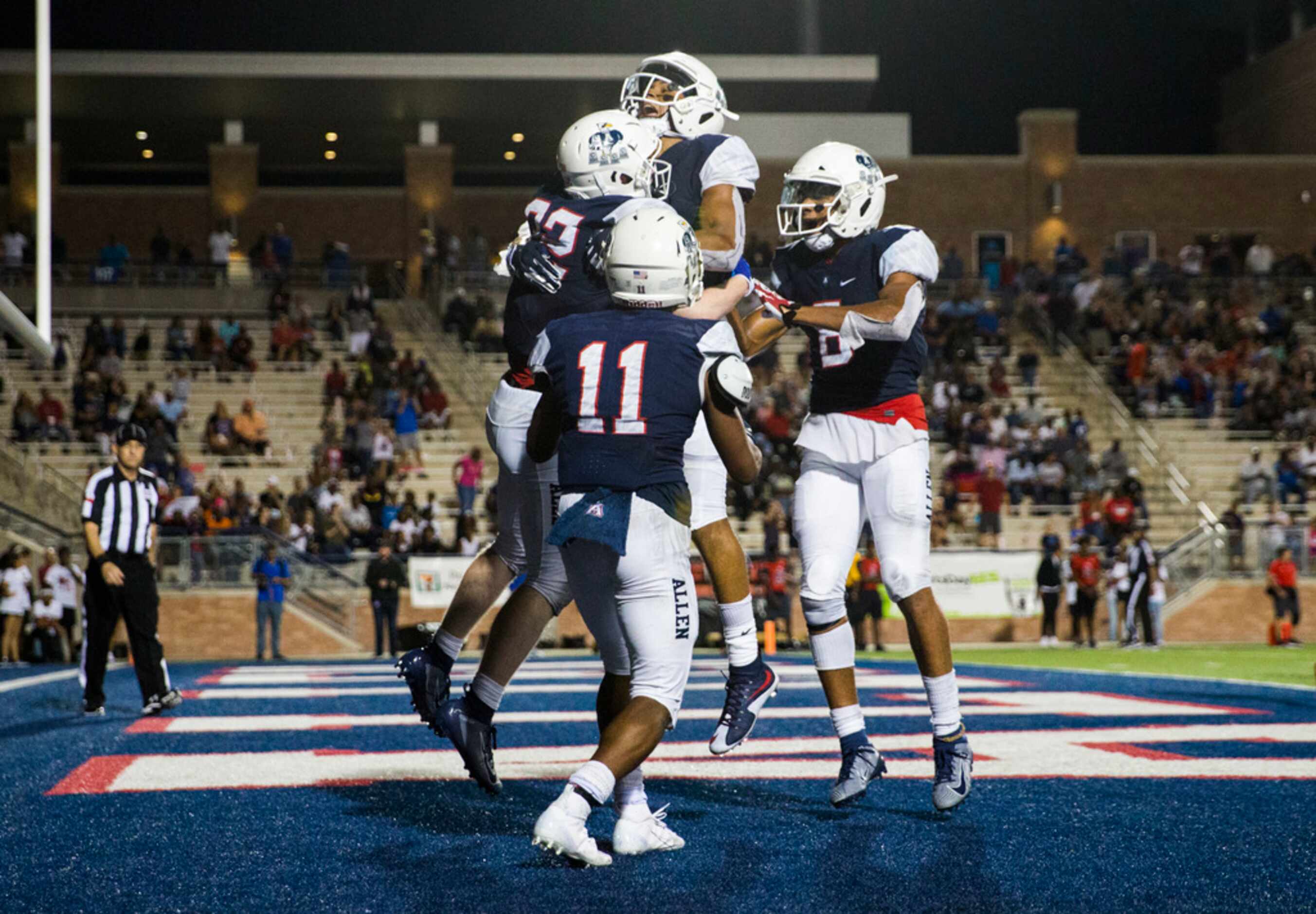 Allen running back Justin Hall (32) celebrates a touchdown with team mates during the fourth...