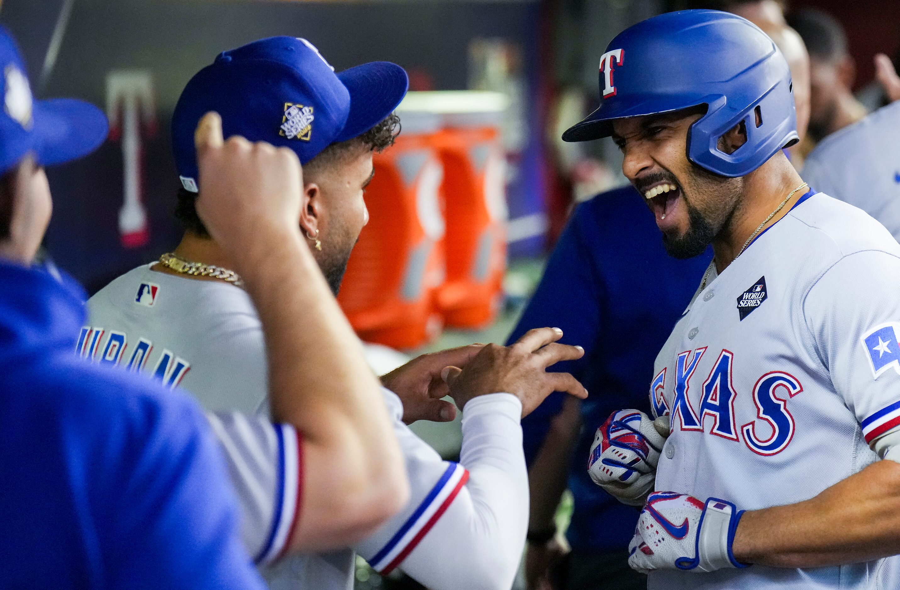 Texas Rangers’ Marcus Semien celebrates in the dugout after hitting a three-run home run...