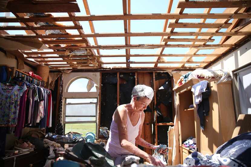 Melody Palmros salvages items from a room in her damaged home in Port Aransas on Saturday,...