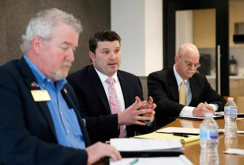 Dallas attorney J.J. Koch (center) answers a question during a February Dallas Morning News...