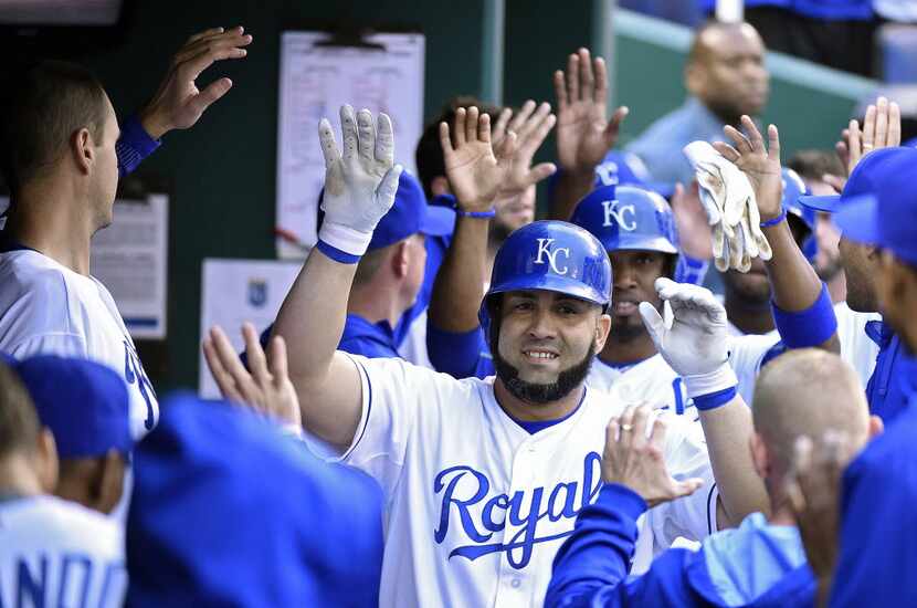 The Kansas City Royals' Kendrys Morales is congratulated after a three-run home run in the...