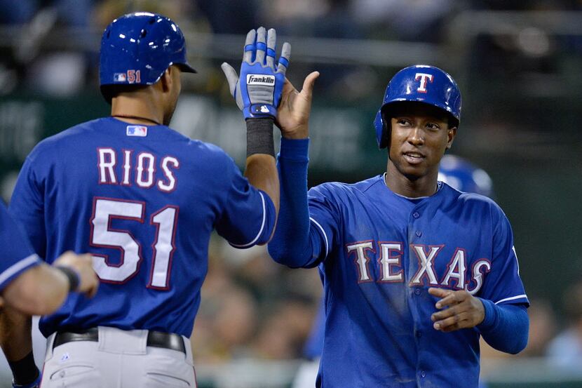 OAKLAND, CA - SEPTEMBER 03:  Jurickson Profar #13 of the Texas Rangers is congratulated by...