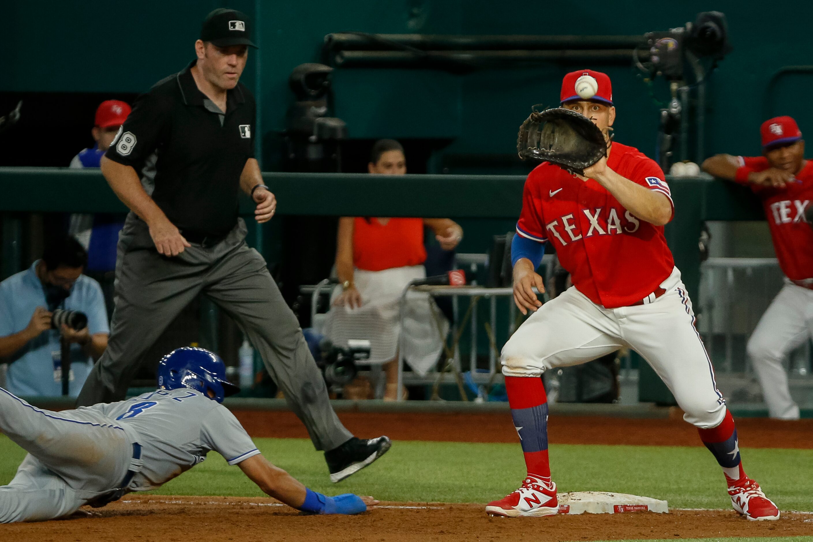 Texas Rangers first baseman Nate Lowe (30) eyes the ball ahead of Kansas City Royals...