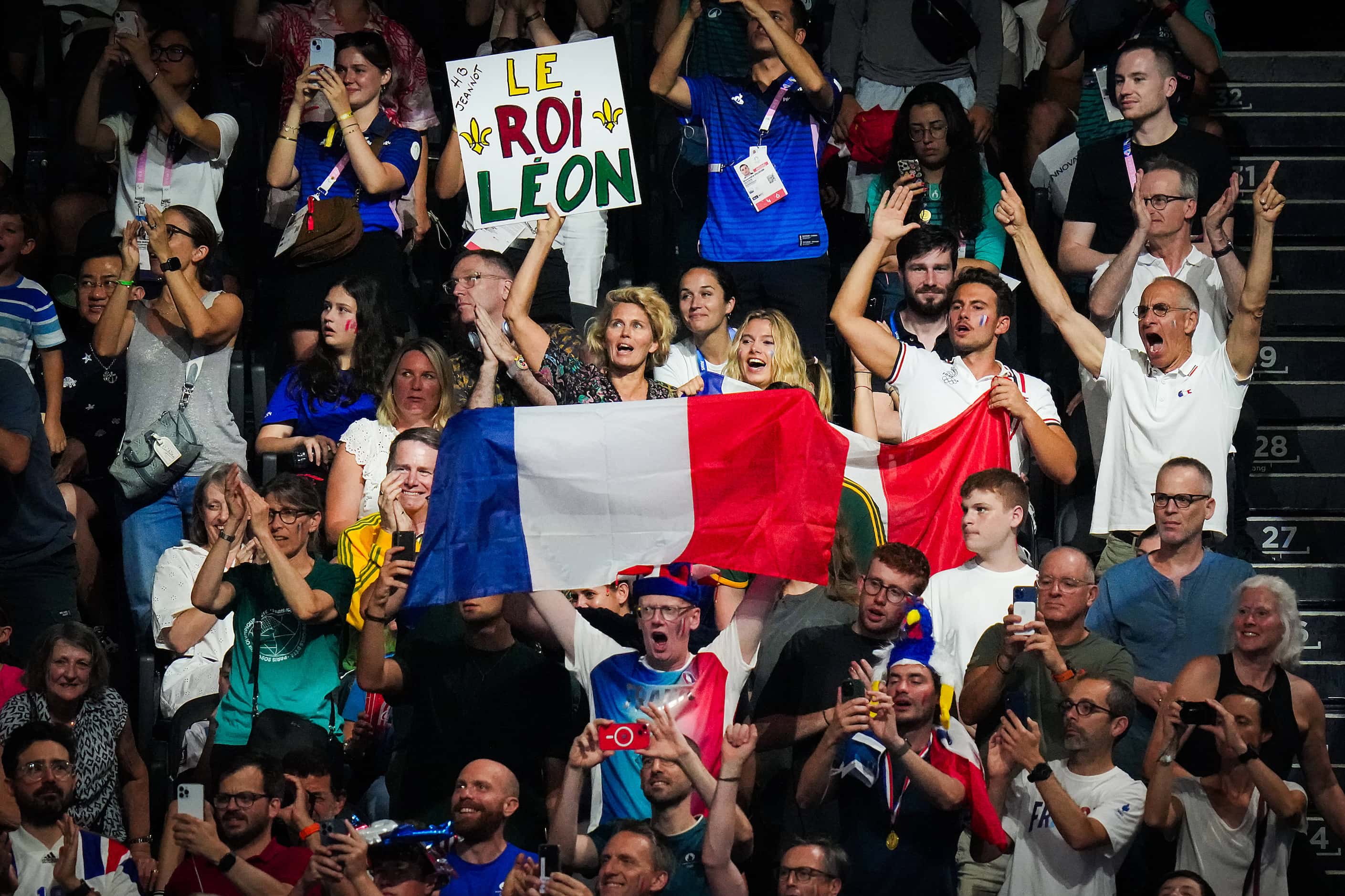 Fans cheer Leon Marchand of France before the men’s 200-meter breaststroke final at the 2024...