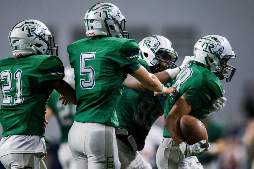 Frisco Reedy players celebrate an interception by defensive back Keaton Dickey (28) during...