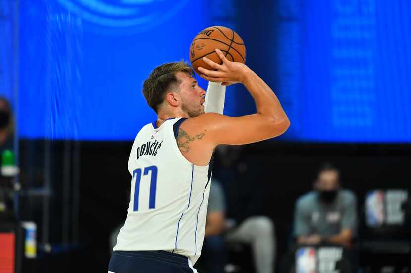 Orlando, FL - JULY 26: Luka Doncic #77 of the Dallas Mavericks shoots a free-throw during a...