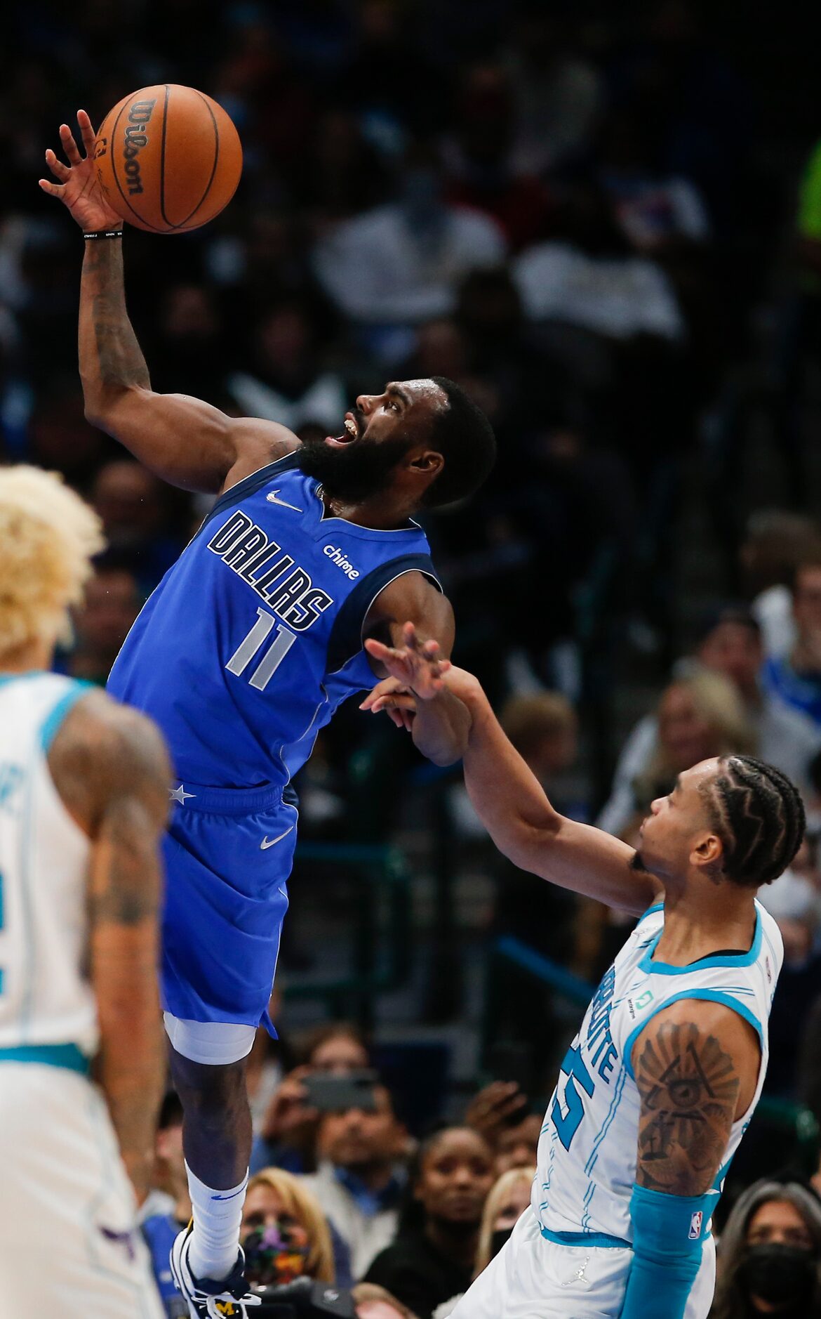 Dallas Mavericks forward Tim Hardaway Jr. (11) is fouled by Charlotte Hornets forward P.J....