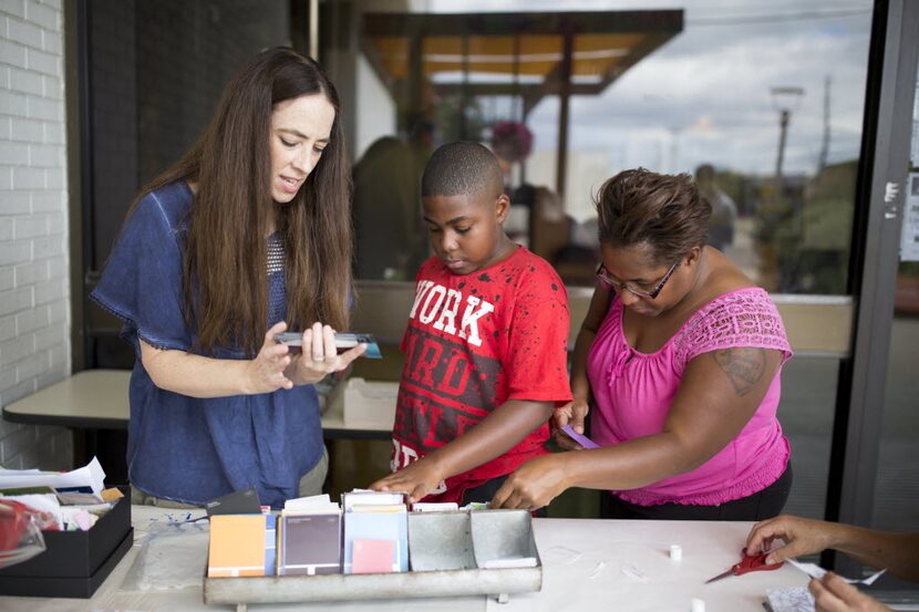 Kendrick Linnear (center), 11, of Dallas, and his mother Brandy Redwine (right) participate...