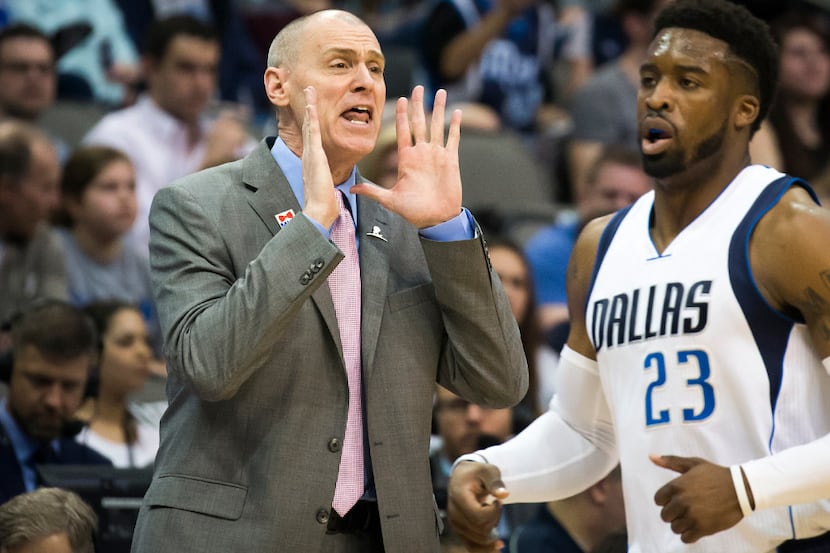 Dallas Mavericks head coach Rick Carlisle shouts instructions toward guard Wesley Matthews...