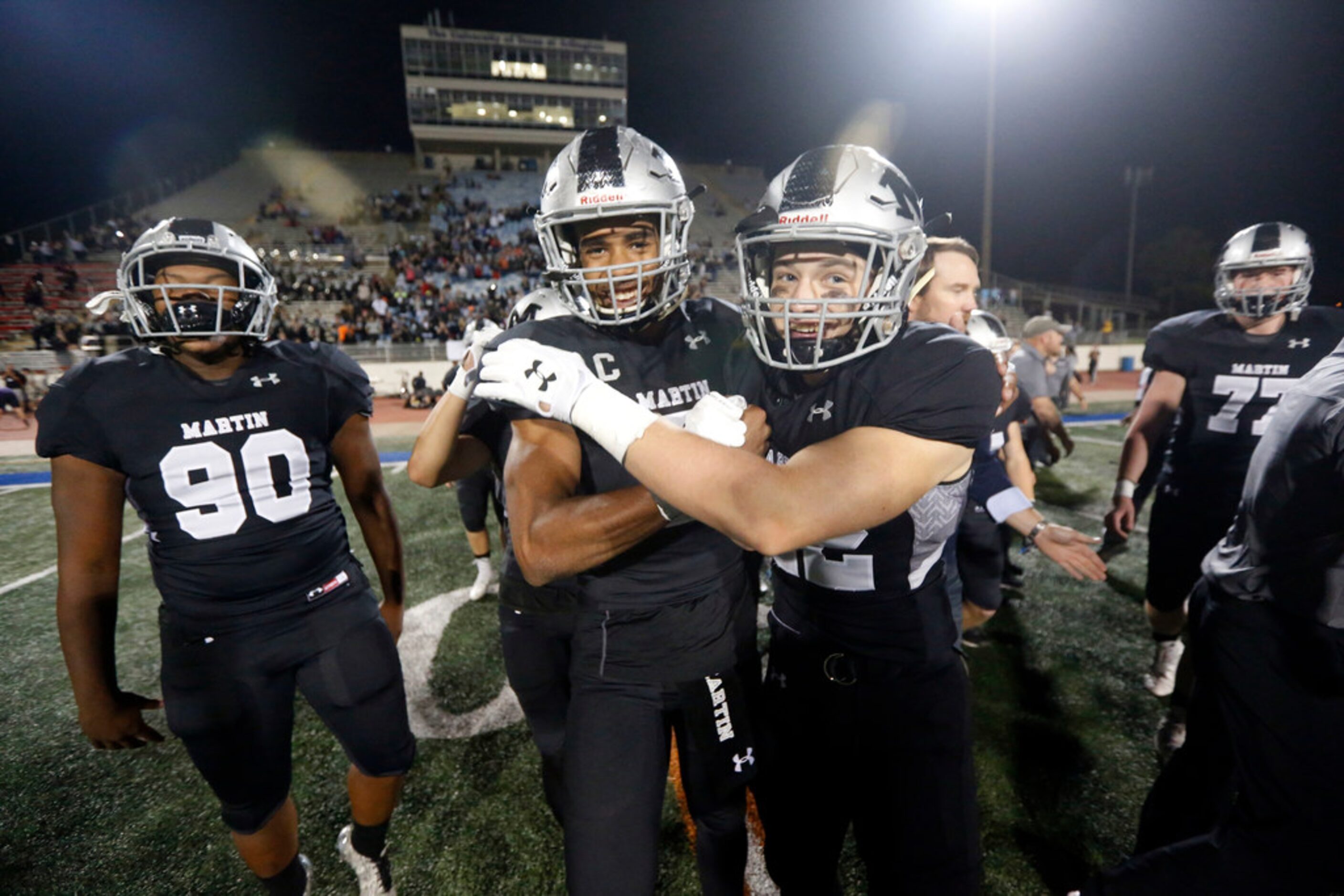 Arlington Martin players Shondrick Davenport (90), Brayden Willis (7) and Nick Hight (22)...