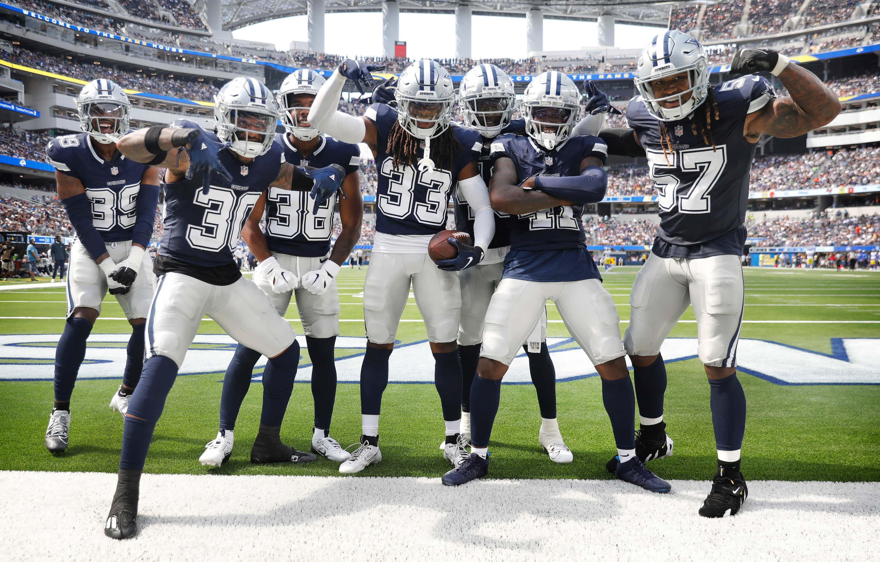 Dallas Cowboys safety Julius Wood (33) and his teammates celebrate his interception of Los...