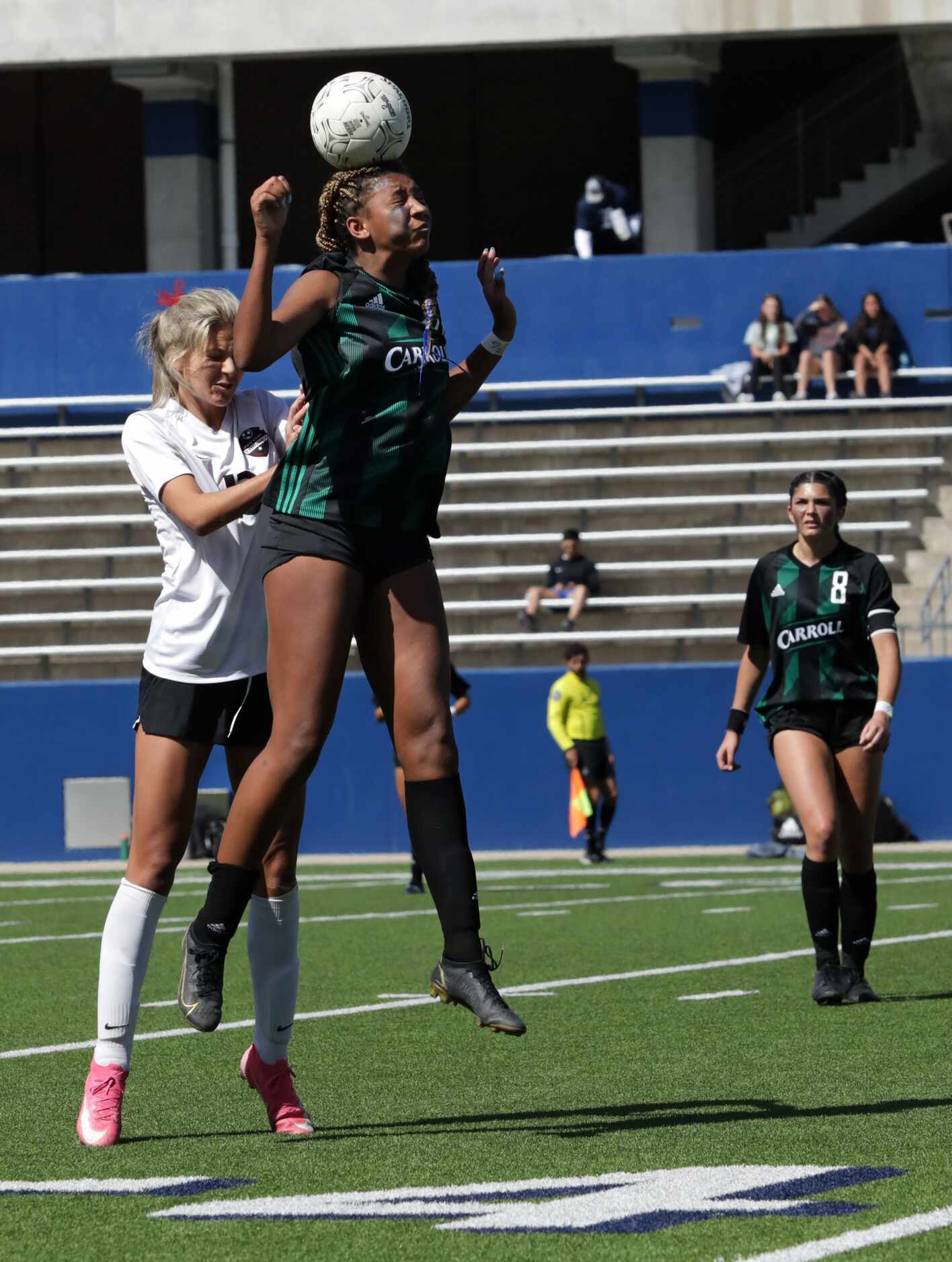 Southlake Carroll player #20, Zoe Matthews, jumps for the ball as Flower Mound Marcus player...