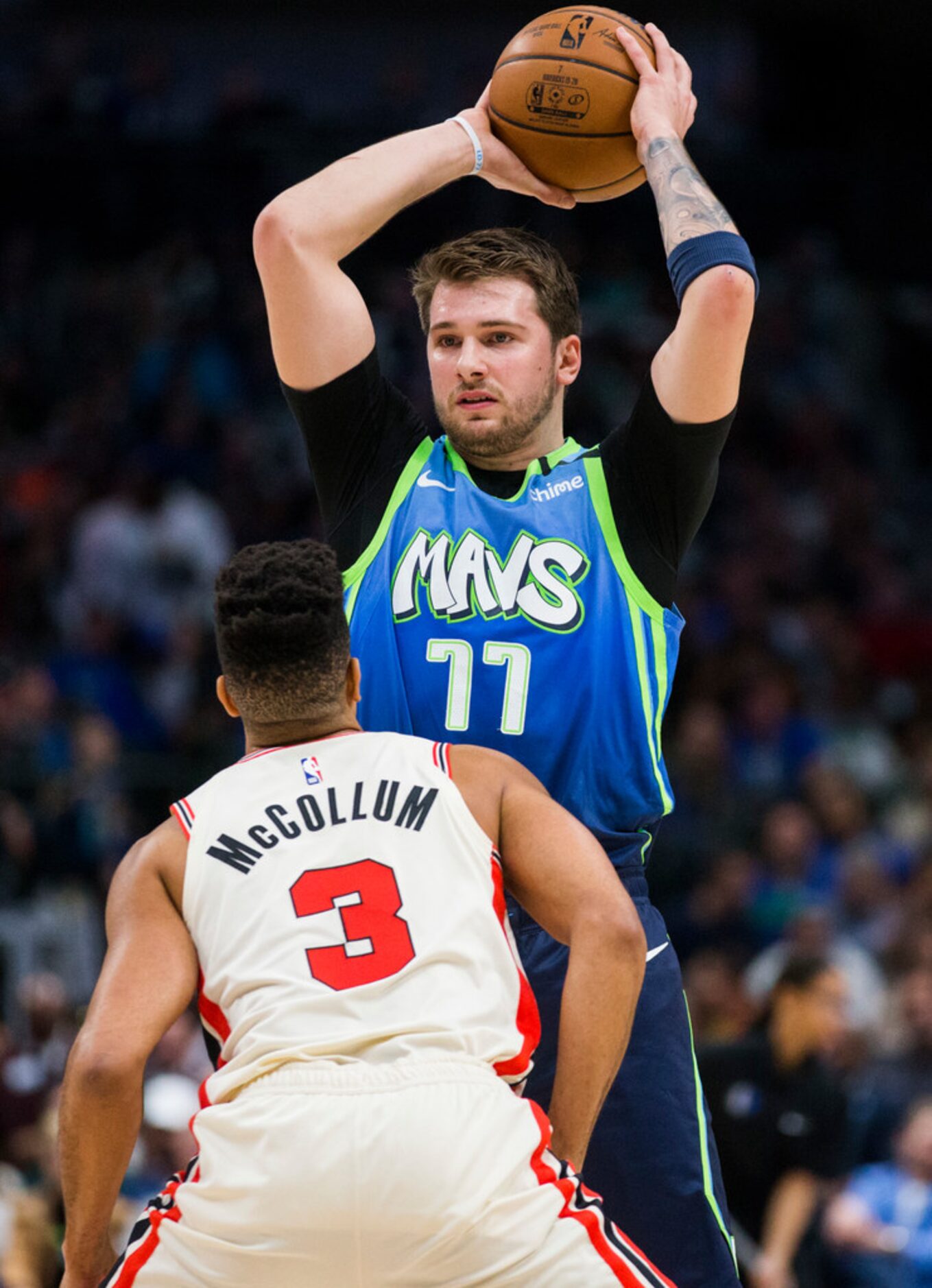 Dallas Mavericks forward Luka Doncic (77) looks for a pass over Portland Trail Blazers guard...