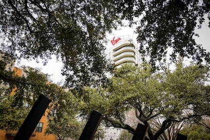 Virgin Hotels Dallas rises over a tree-lined esplanade on Monday, Dec. 16, 2019, in Dallas....