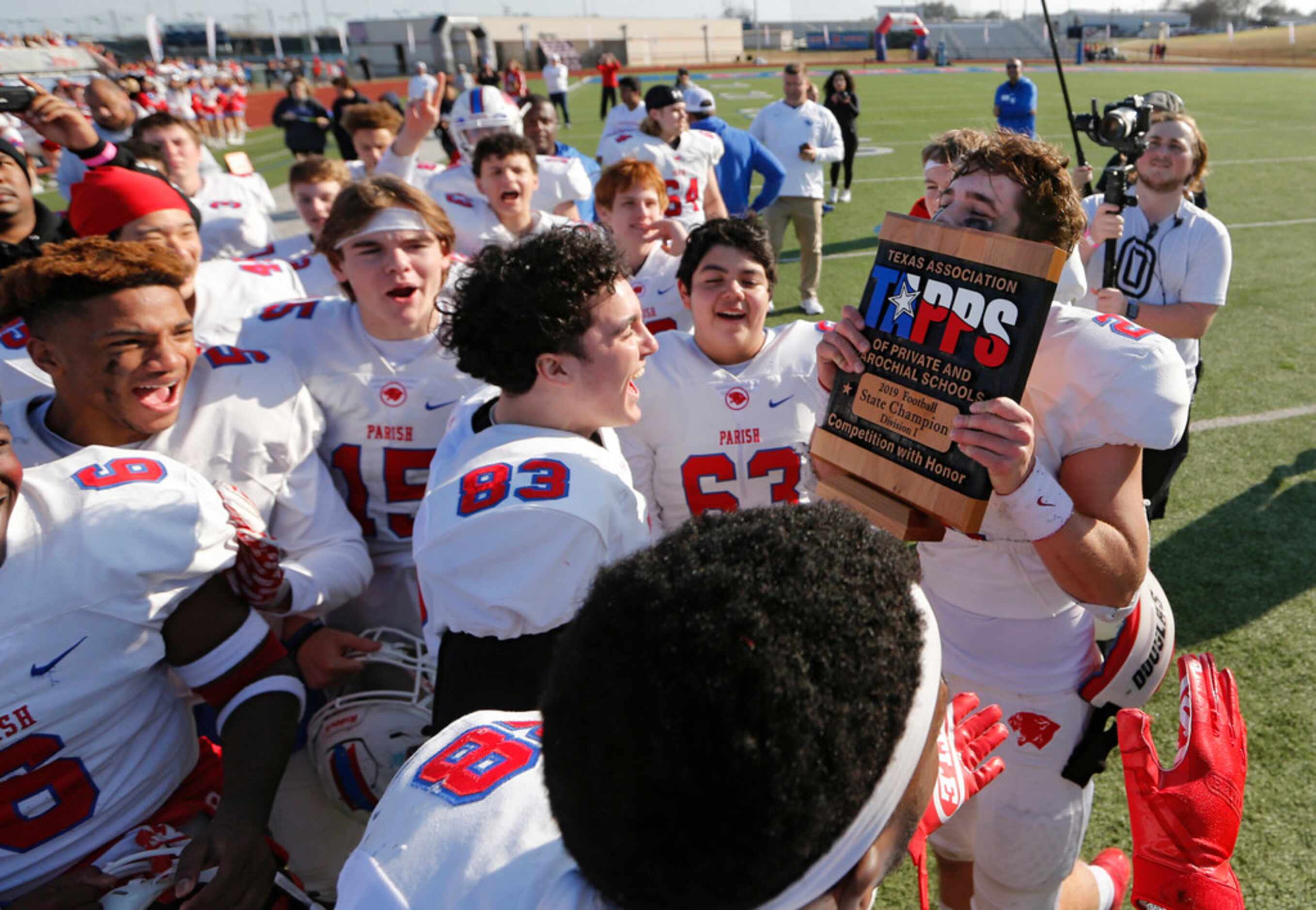 Parish Episcopal's Preston Stone (2) kisses the trophy after receiving it during the awards...