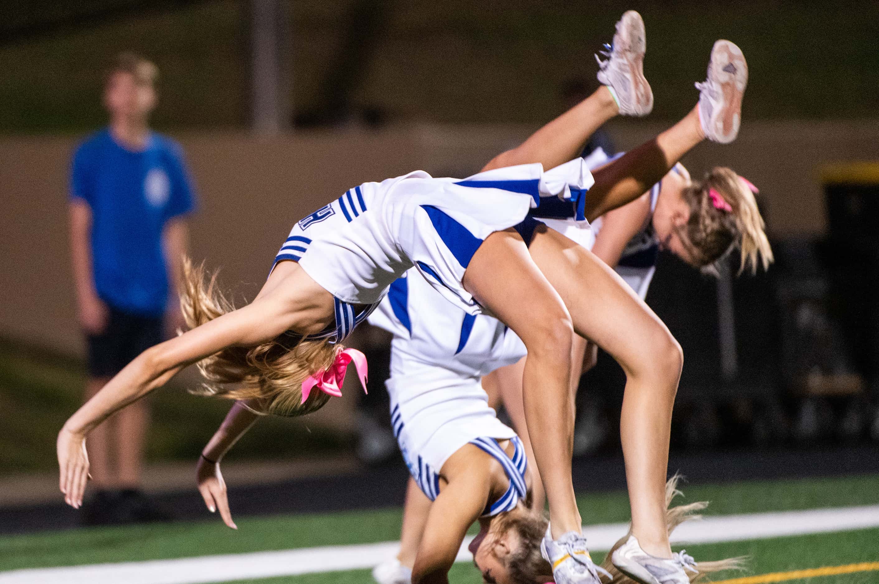 Hebron cheerleaders do flips after a touchdown in the first half during a high school...