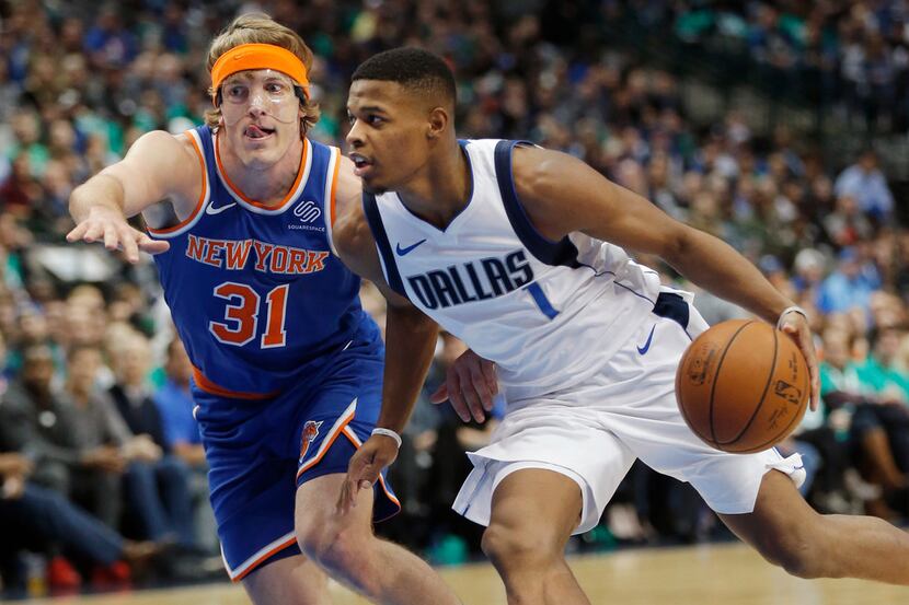 Dallas Mavericks guard Dennis Smith Jr. (1) battles New York Knicks guard Ron Baker (31) for...