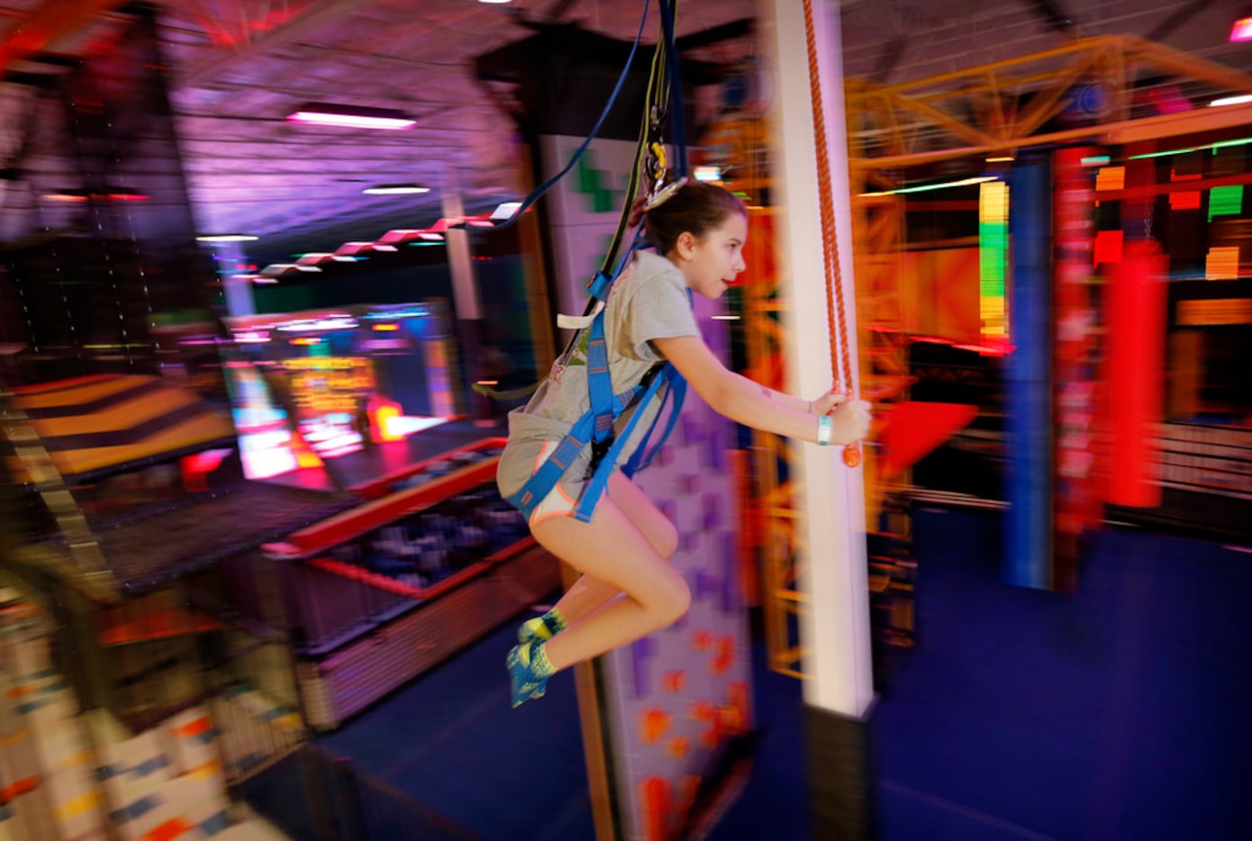 Ainsley Alexander, 11, of Grapevine is a blur as she rides the Sky Rider track around the...