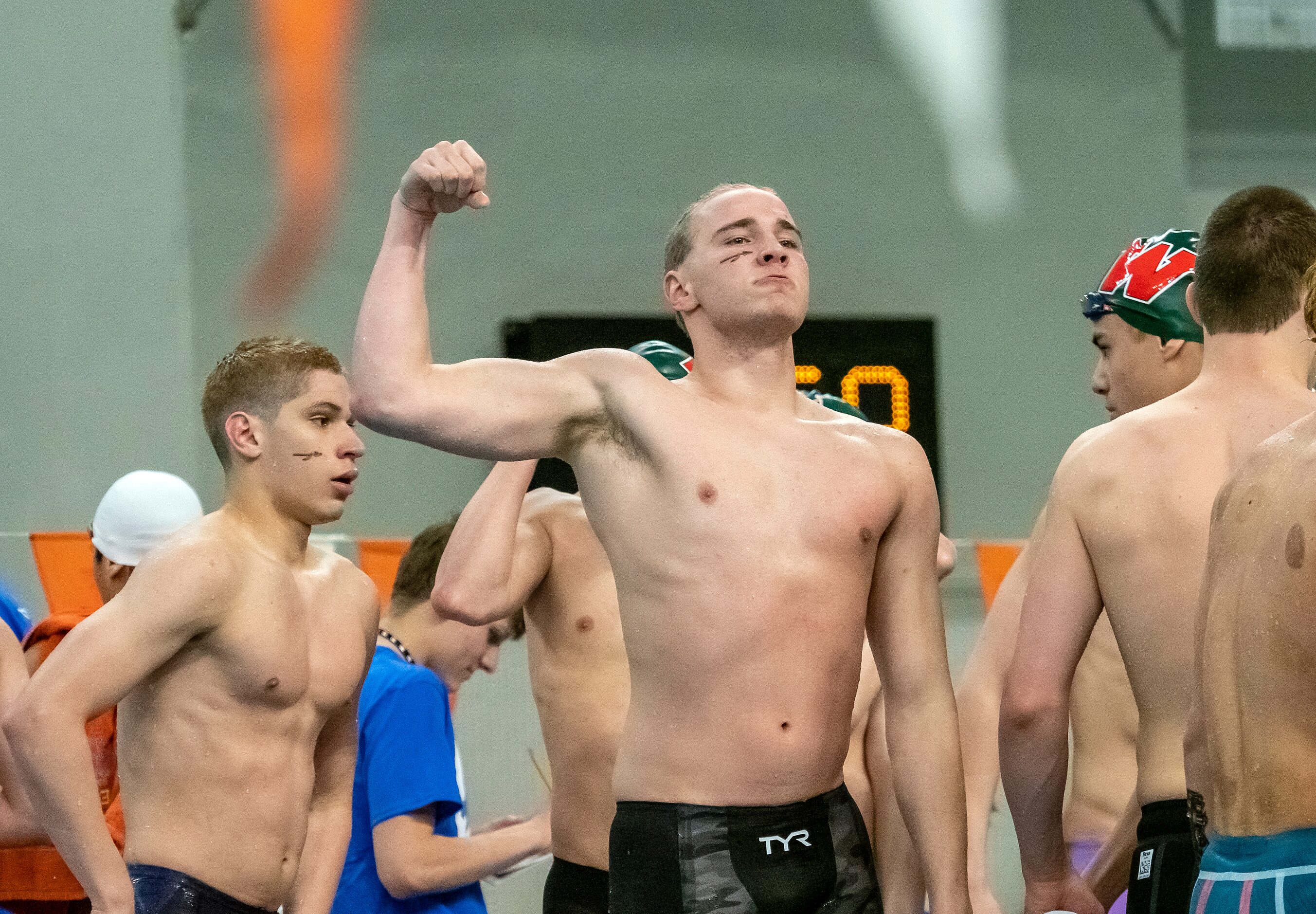 Keller’s Jacob Fabian flexes his arm after he and teammates won their heat in the 200...