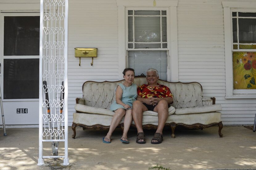 Johnny Rincon and his wife, Sarah, sit on the porch of their rented home on Harry Hines...