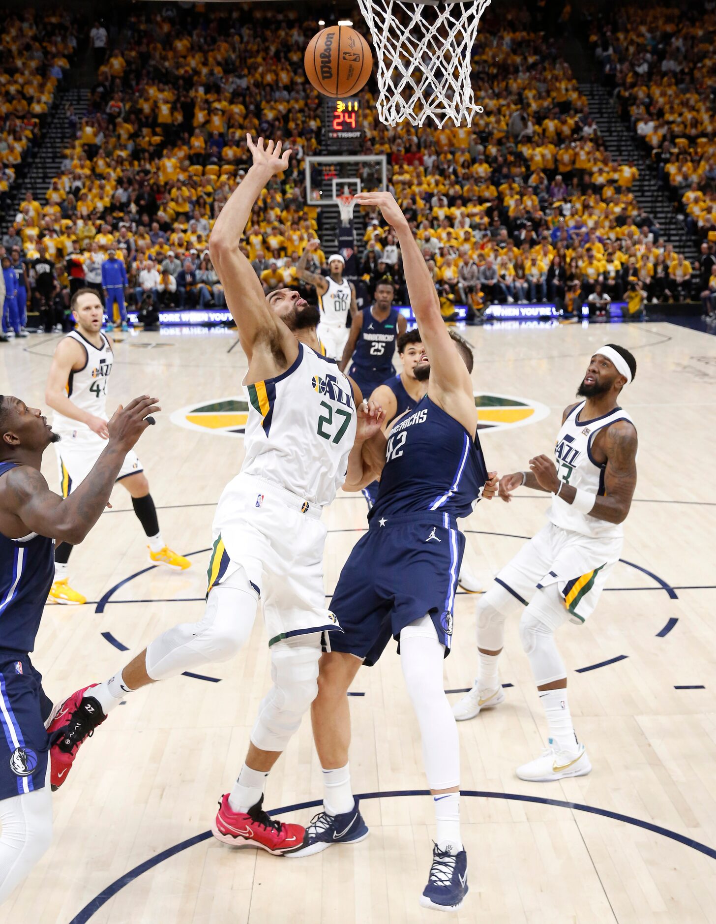 Utah Jazz center Rudy Gobert (27) pulls on the jersey of Dallas Mavericks forward Maxi...