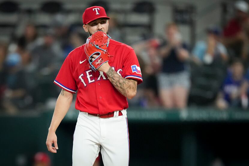 Texas Rangers relief pitcher Joe Barlow reacts after giving up a 2-run home run to Seattle...