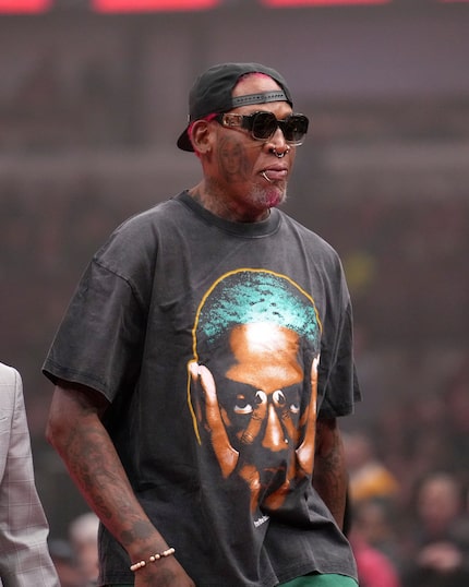 Former Chicago Bulls forward Dennis Rodman walks off the court before the start of an NBA...