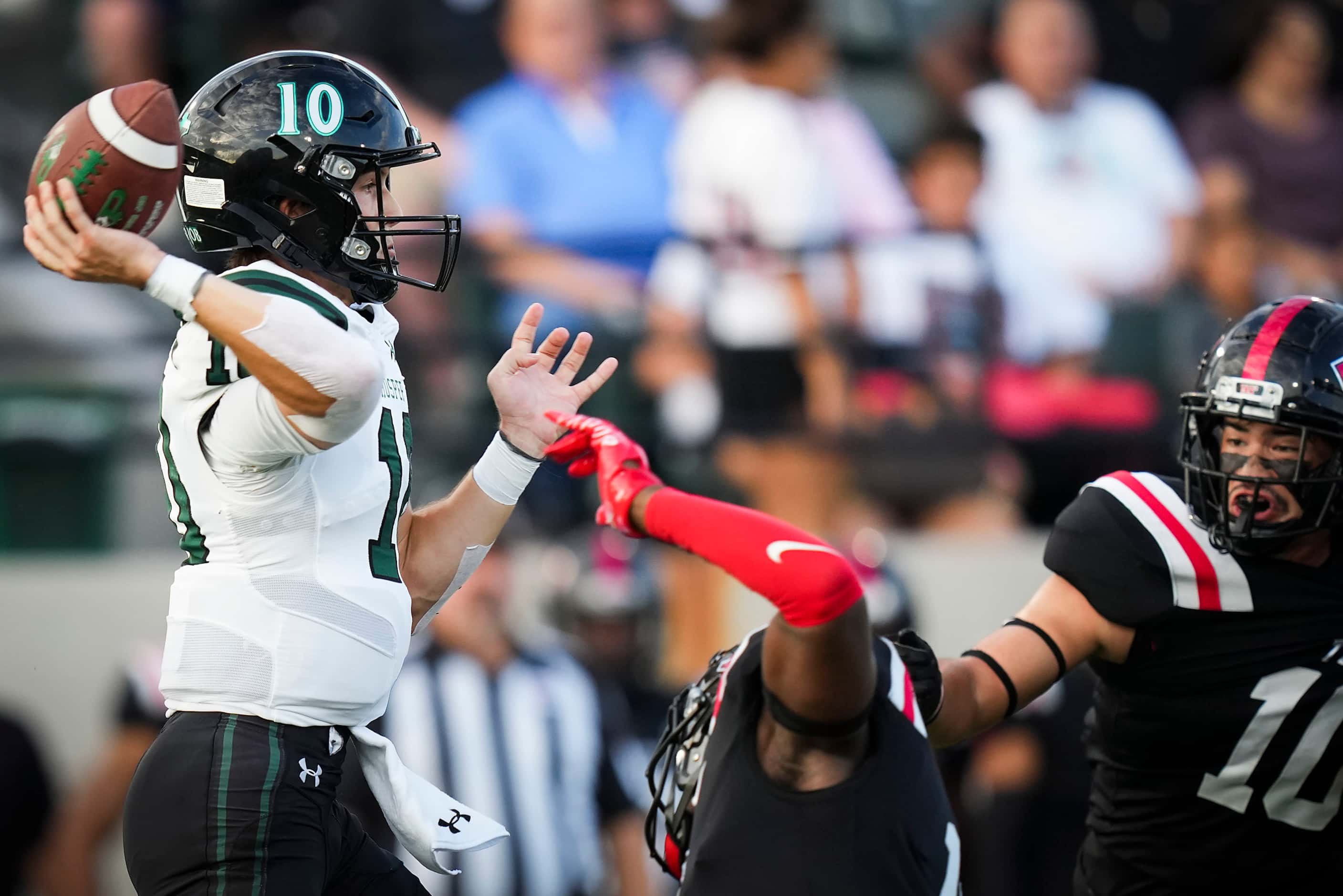 Prosper players huddle around quarterback  Harrison Rosar (10) throws a pass during the...