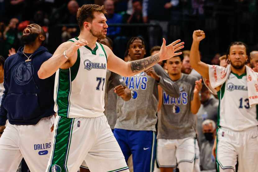 Dallas Mavericks guard Luka Doncic (77) celebrates with teammates the win over Golden State...