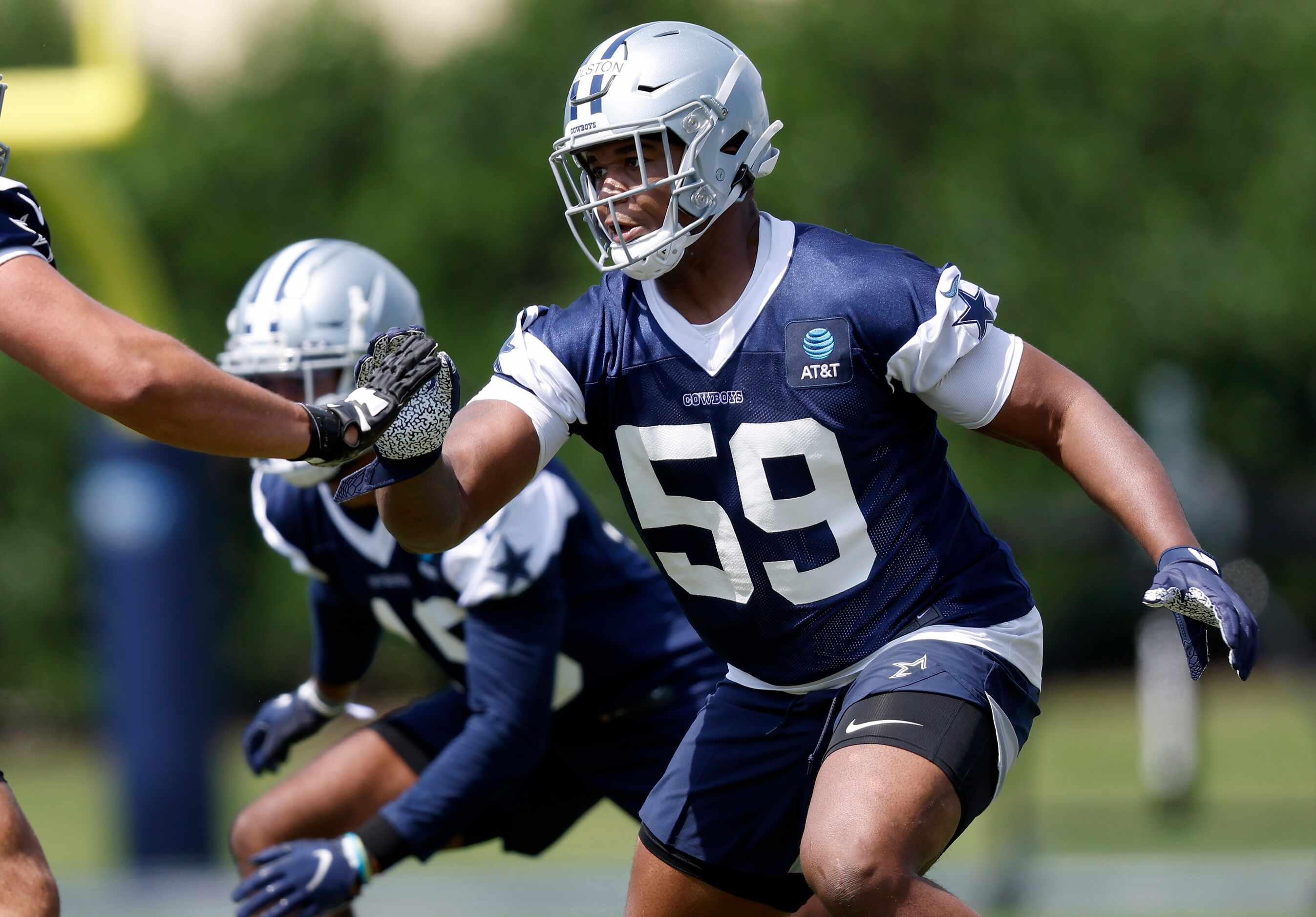 Dallas Cowboys rookie defensive end Chauncey Golston (59) pass rushes during team drills at...