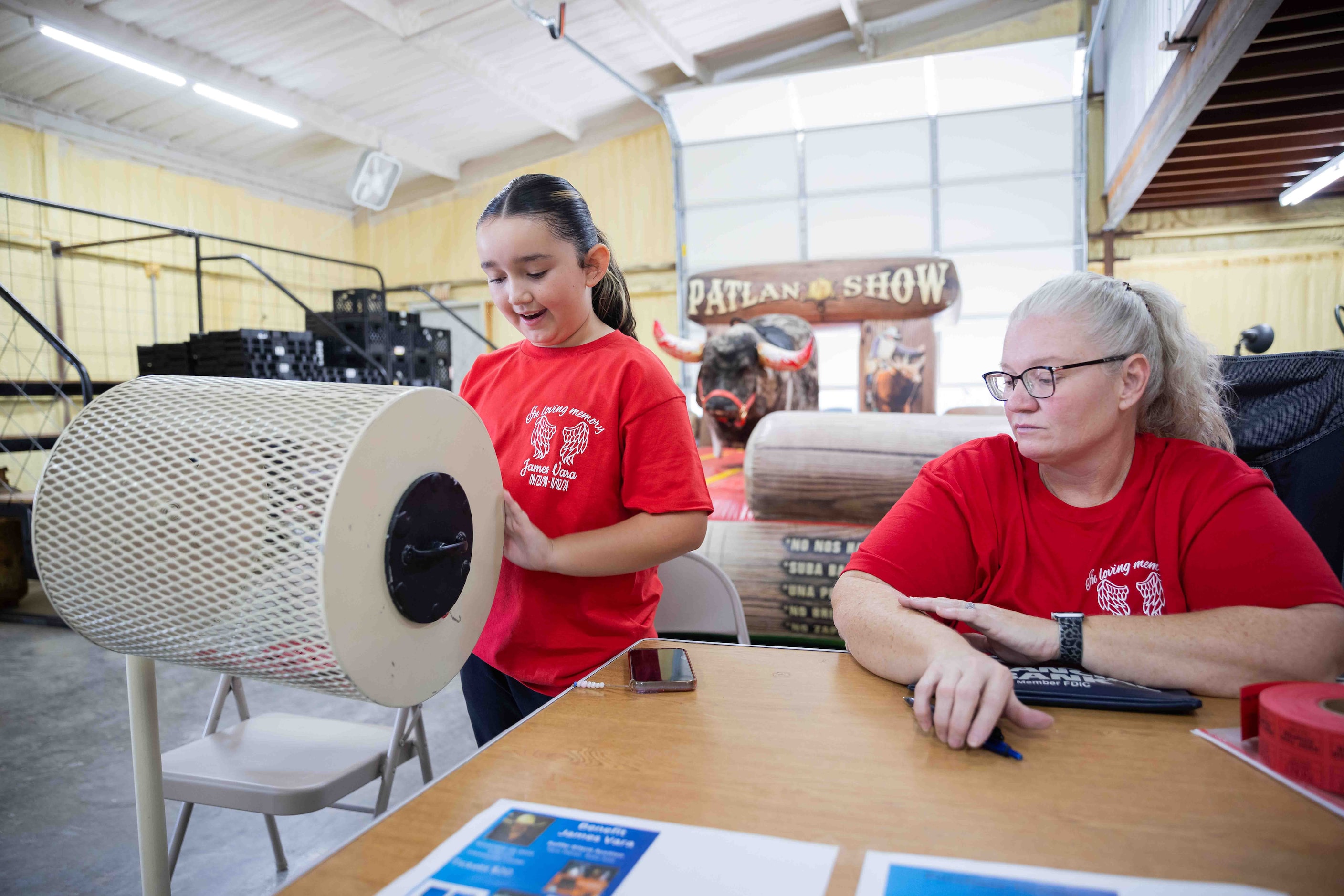 Kristy Mora, aunt of James Vara Jr., watches as granddaughter Amber Elizando, 9, spins the...