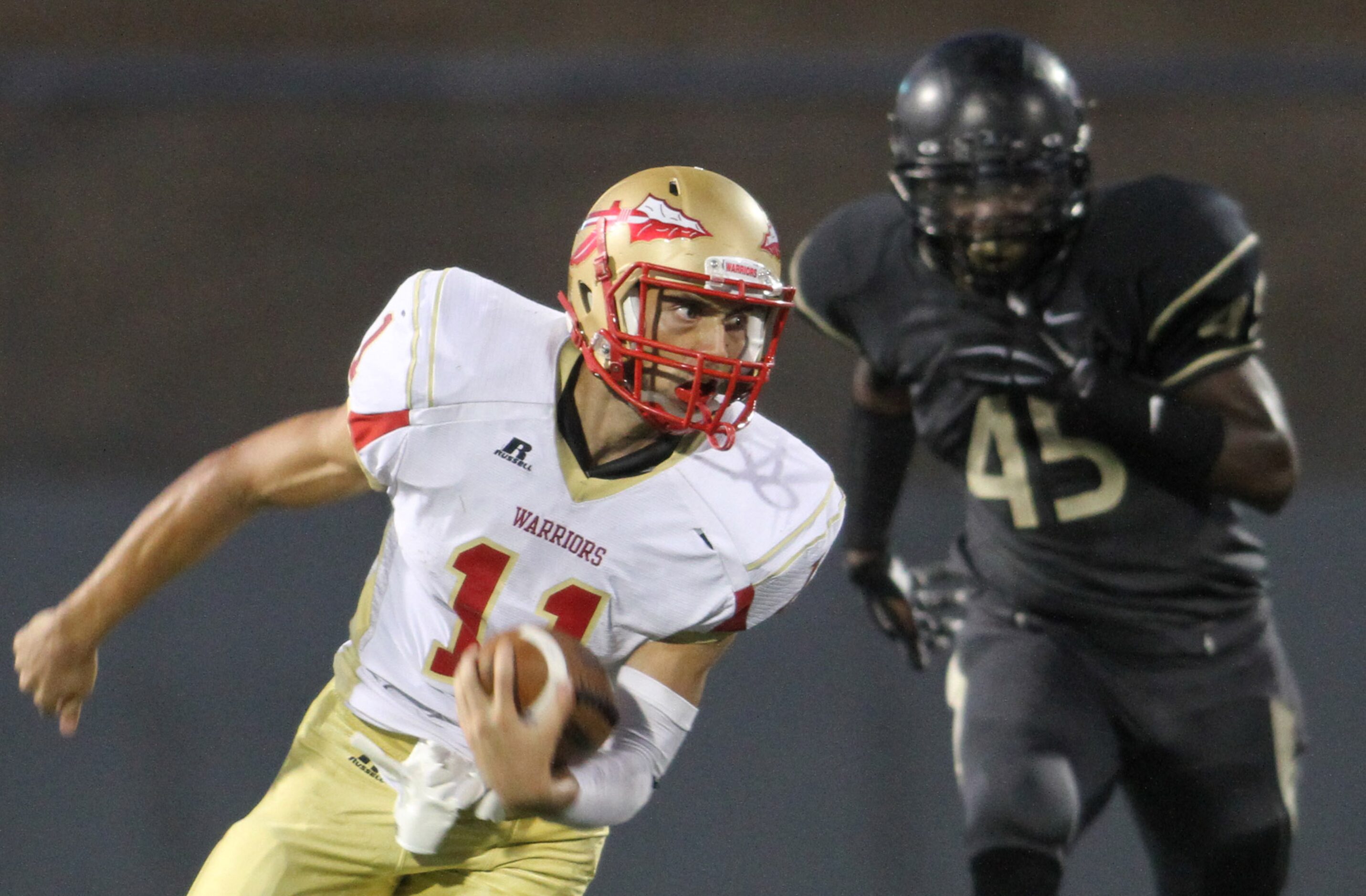 South Grand Prairie quarterback Greg Eisworth (11) cuts inside a block of a teammate as...