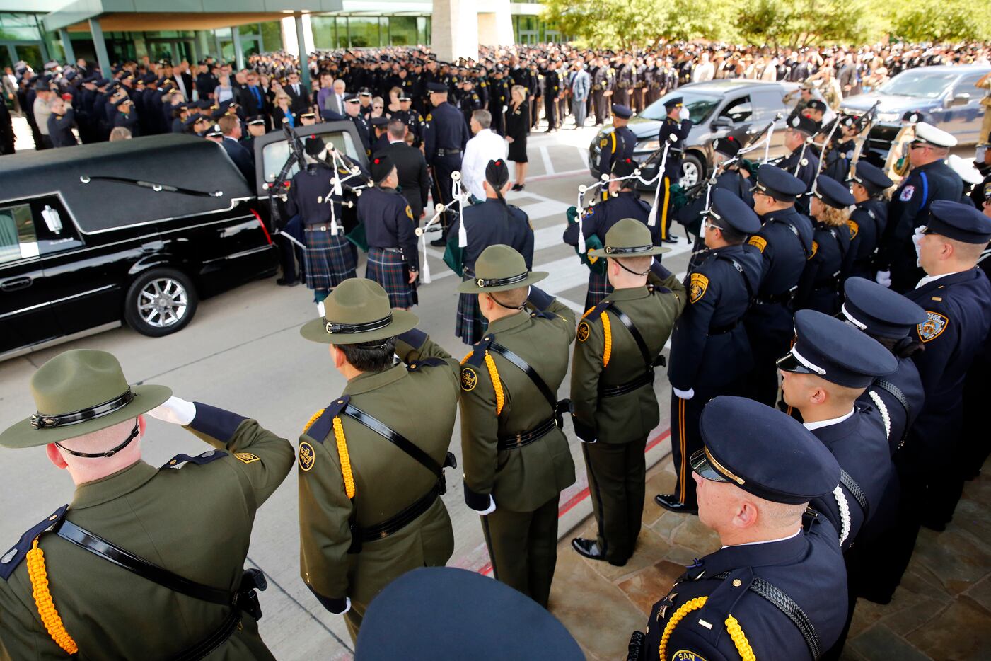 Border Patrol officers saluted fallen Dallas police Officer Lorne Ahrens as his casket was...