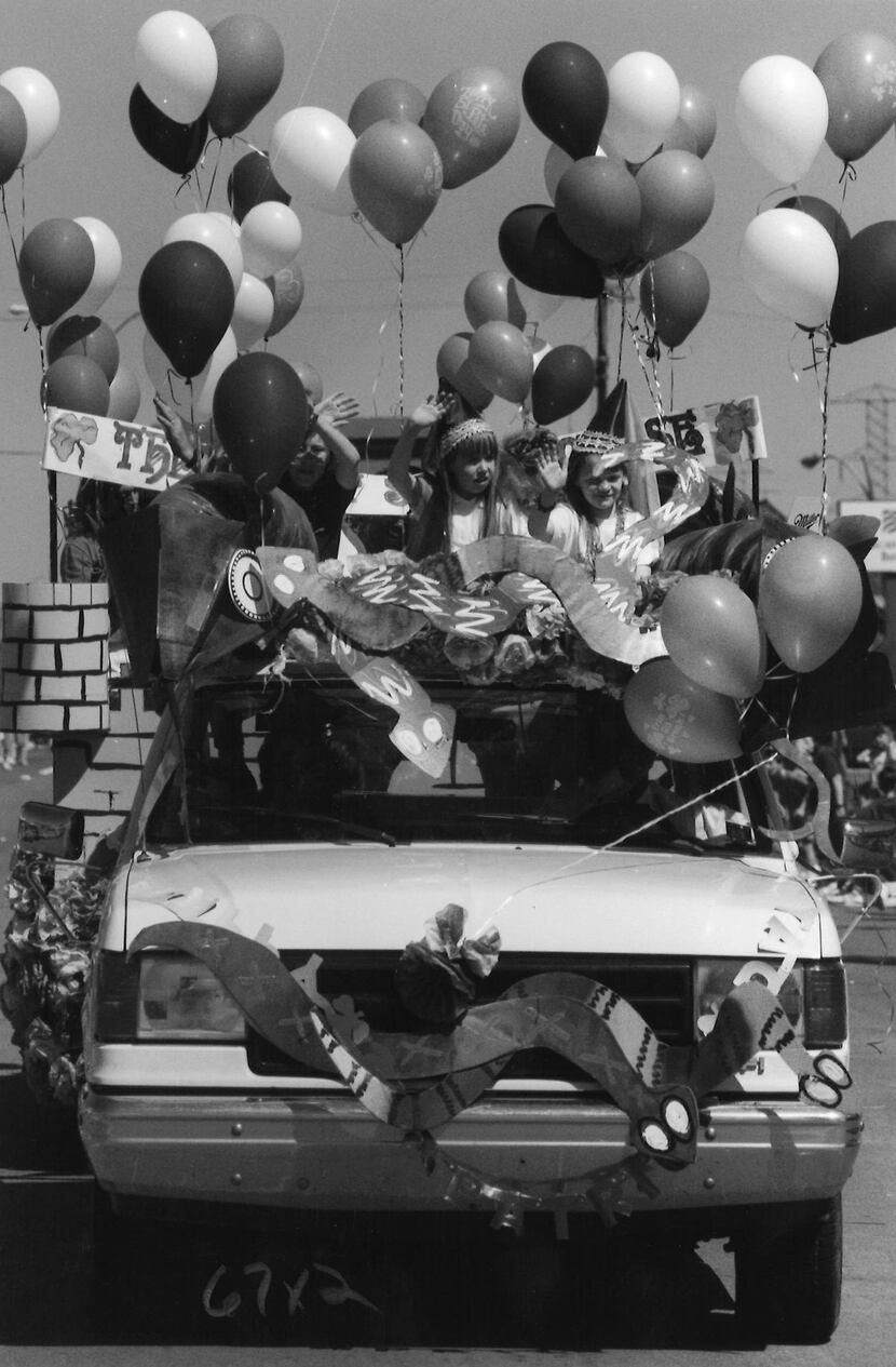 March 17, 1990: Kids wave while riding in the Greenville Avenue parade.