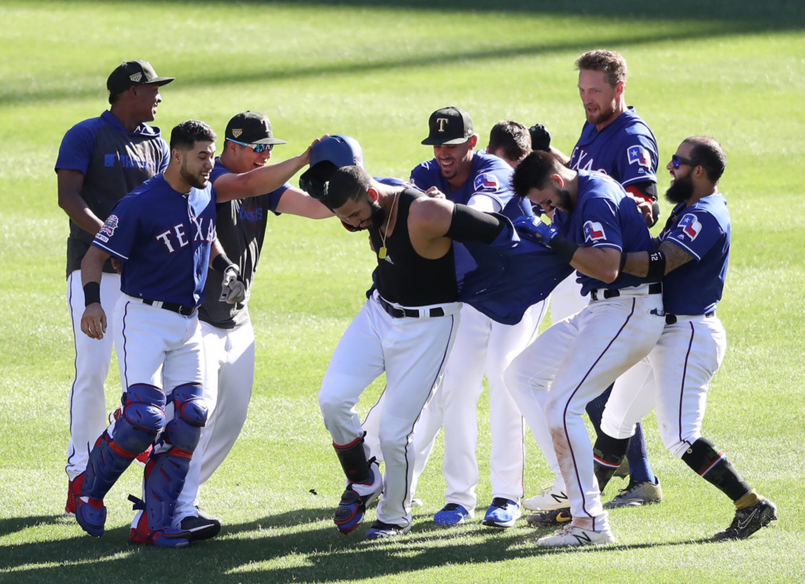 ARLINGTON, TEXAS - MAY 19:  The Texas Rangers celebrate the game winning run scored on a...