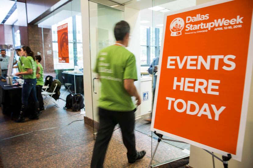 A volunteer enters a lounge area during Dallas Startup Week activities in April.  (Ashley...