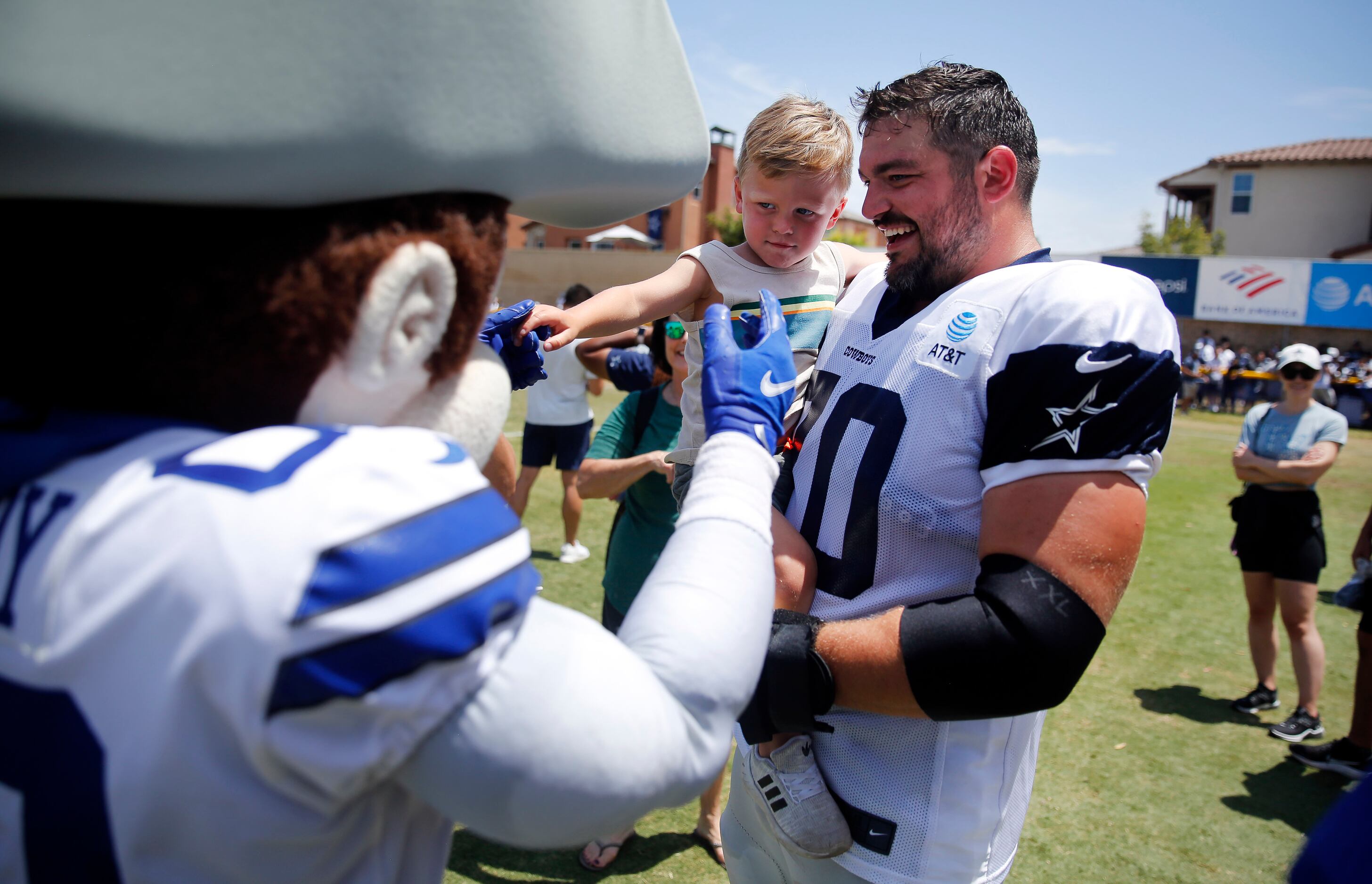 Dallas Cowboys guard Zack Martin introduces his son Charlie to the mascot, Rowdy, following...